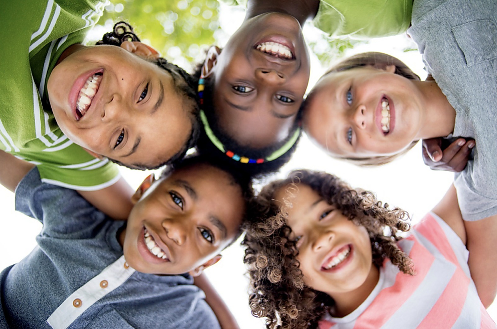 A joyful group of children laughing together outdoors